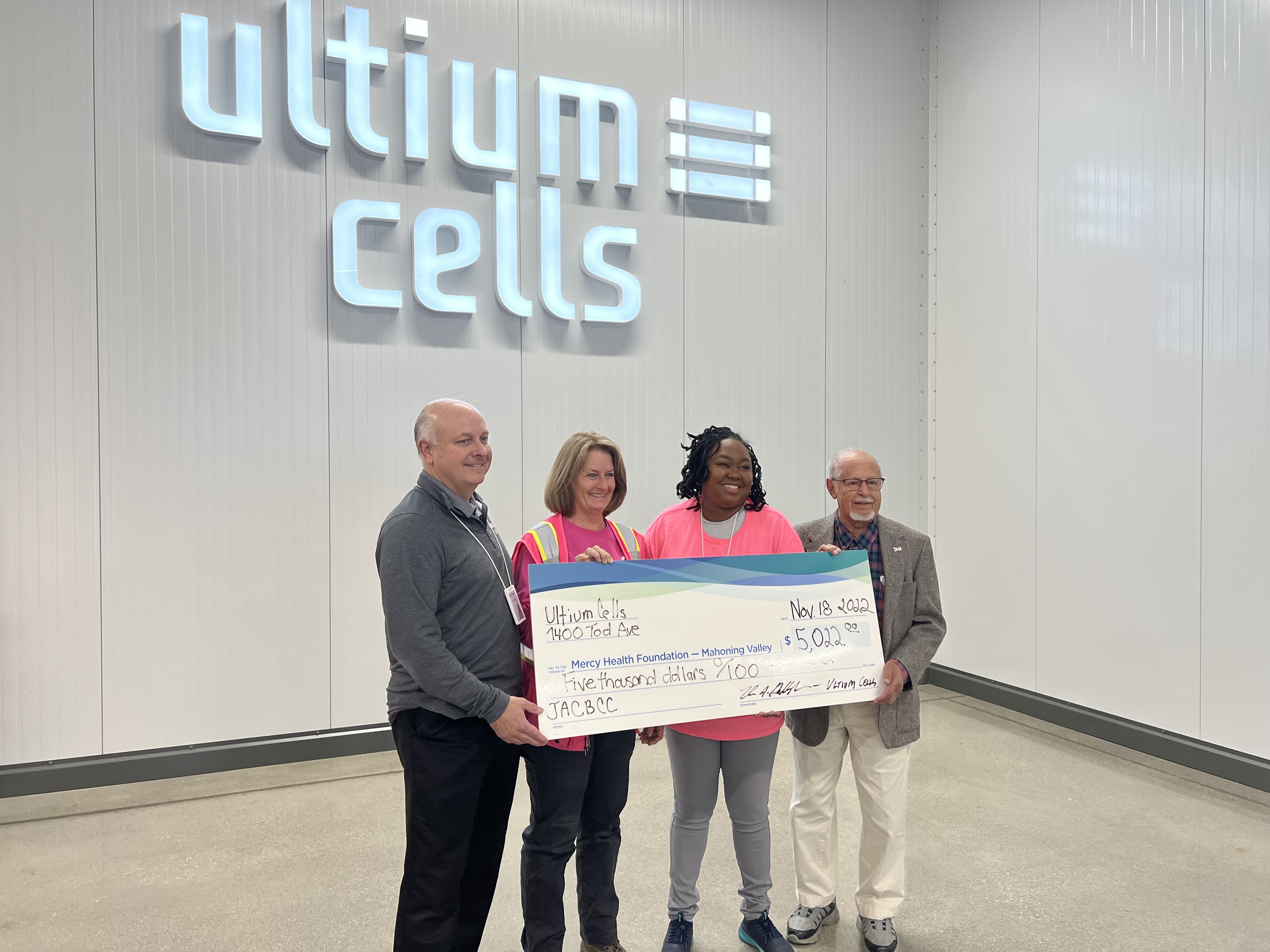 Ultium Cells team members present the check to Dr. Abdu. 
